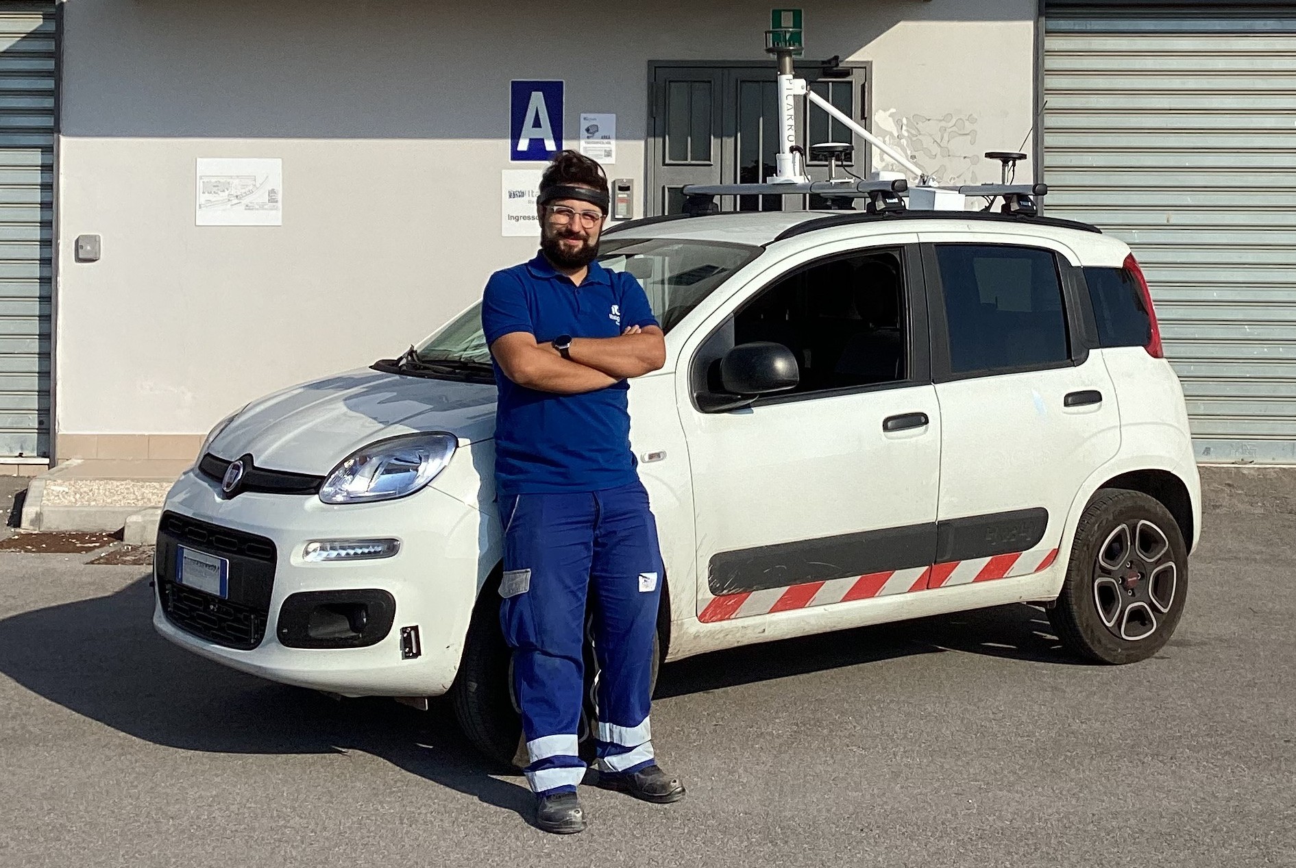 Professional driver operating in remote areas while wearing Aigo, a device for monitoring driver attention and fatigue.